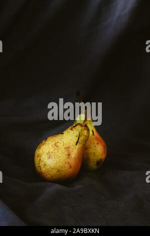 two ripe juicy pears on a black background Stock Photo