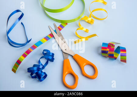 A close up of scissors and assorted mulit colored ribbons for craft. Stock Photo