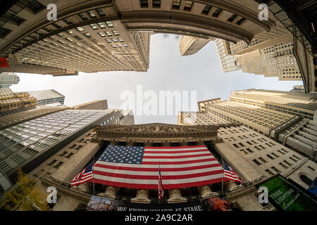 A giant American flag is unfurled across the facade of the New York Stock Exchange to commemorate Veterans Day in New York on Monday, November 11, 2019. Originally knows as Armistice Day, the holiday memorializes that on the eleventh hour of the eleventh day of the eleventh month the guns fell silent in1918 marking the end of World War I.  The holiday has since been expanded to include all American soldiers from all wars.(© Richard B. Levine) Stock Photo