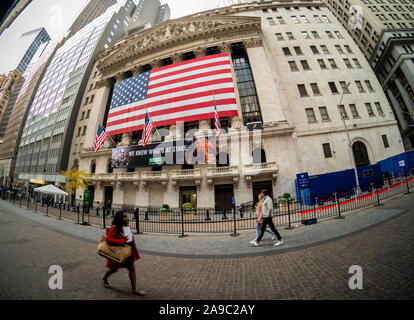 A giant American flag is unfurled across the facade of the New York Stock Exchange to commemorate Veterans Day in New York on Monday, November 11, 2019. Originally knows as Armistice Day, the holiday memorializes that on the eleventh hour of the eleventh day of the eleventh month the guns fell silent in1918 marking the end of World War I.  The holiday has since been expanded to include all American soldiers from all wars.(© Richard B. Levine) Stock Photo