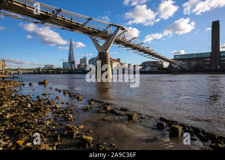 London, UK - January 28th 2019: A view from the shore of the River Thames in London.  This view takes in the sights of Southwark Bridge, The Shard, th Stock Photo