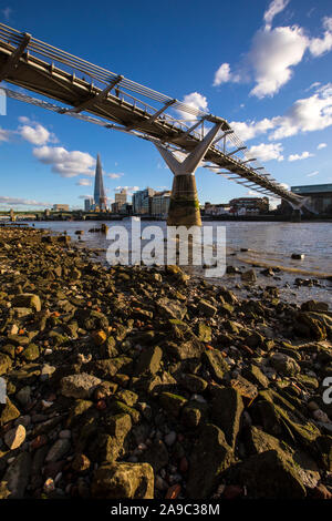 London, UK - January 28th 2019: A view from the shore of the River Thames in London, UK.  This view takes in the sights of Southwark Bridge, The Shard Stock Photo