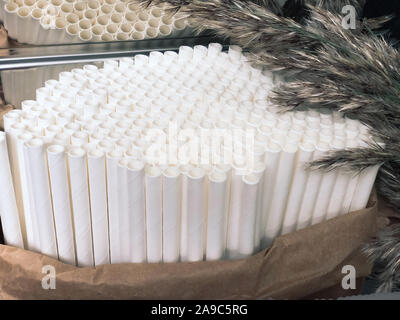 White paper straws in cafe. Eco friendly concept for reducing plastic water pollution. Plastic-free and Nature protection lifestyle. Mobile photograph Stock Photo