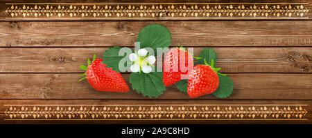 Strawberries with leaves and blossoms on wooden background Stock Photo