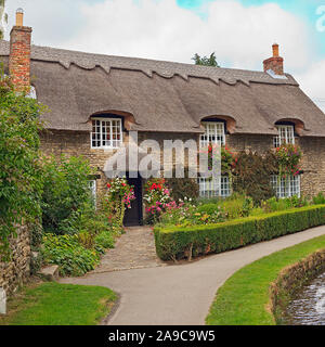 Thatched Cottage by the Beck in Thornton-le-Dale North Yorkshire Stock Photo