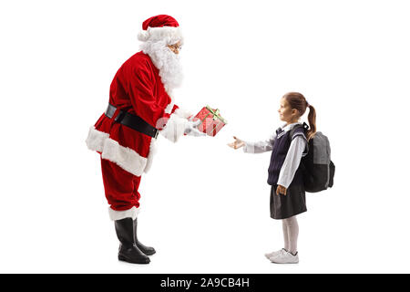Full length profile shot of Santa Claus giving a sparkly red present box to a schoolgirl isolated on white background Stock Photo
