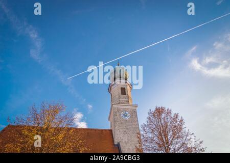 Pilgrimage Church Wallfahrtskirche Heiligenstatt in Tussling, Germany. Airplane contrails on blue sky Stock Photo