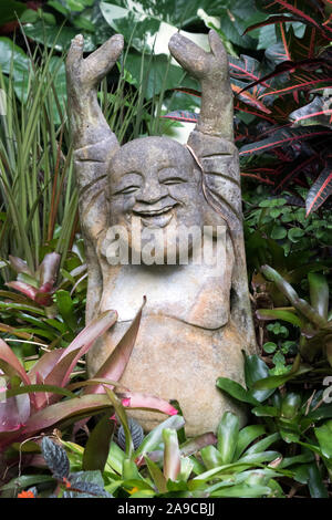 Statue of laughing Buddha in Hunte's Gardens in the parish of St Joseph on Barbados Stock Photo