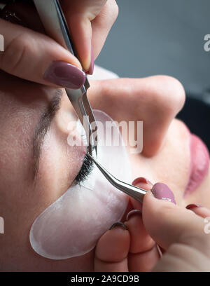 Woman getting a beautiful eyelashes extensions Stock Photo