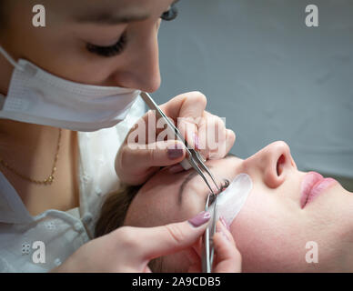 Woman getting a beautiful eyelashes extensions Stock Photo