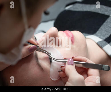 Woman getting a beautiful eyelashes extensions Stock Photo