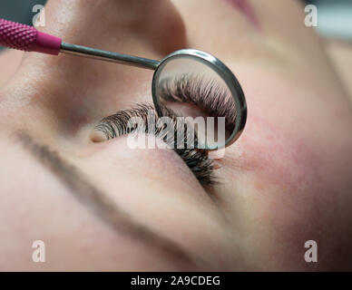 Woman getting a beautiful eyelashes extensions Stock Photo