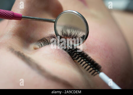 Woman getting a beautiful eyelashes extensions Stock Photo