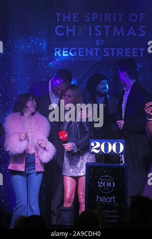 (Front left to right) Maisie Peters, Heart radio presenters Jamie Theakston and Amanda Holden during the Regent Street Christmas lights switch on, London. Stock Photo