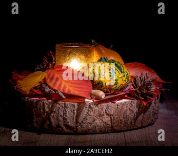 Wonderful autumn composition with multi colored pumpkins and autumnal leaves on a wooden table. Stock Photo