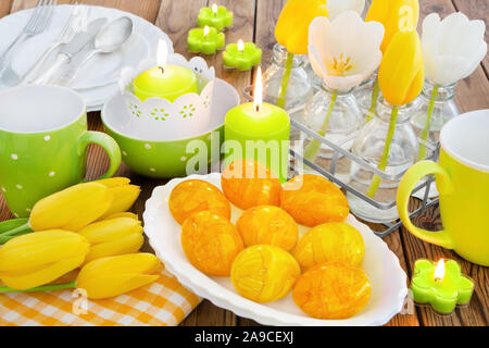 Easter table decorations with eggs and candles Stock Photo