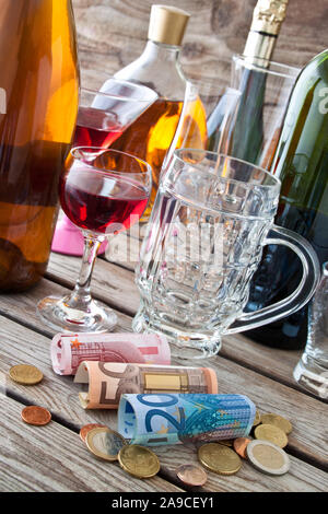 Alcohol drinks and Euro on wooden table Stock Photo