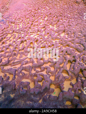 Sand in honeycomb weathered rocks, Rainbow Valley National Park, Northern Territory, Australia, Hermannsburg sandstone Stock Photo