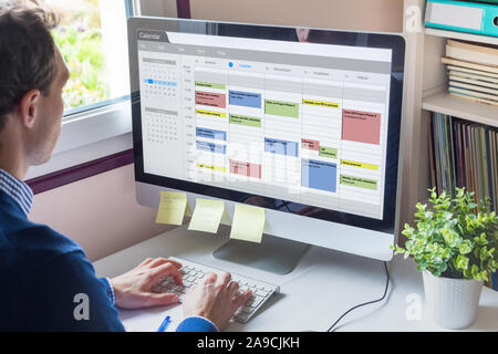 Calendar software showing busy schedule of manager with many meetings, tasks and appointments during the week, time management organization at work co Stock Photo