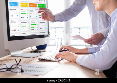 Colleagues working on agile product development board with scrum or kanban framework, lean methodology, iterative or incremental organization project Stock Photo