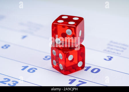 Close-up Of Translucent Two Red Dice On Calendar Stock Photo