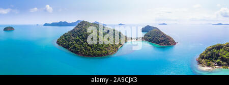 Aerial panorama of tropical island landscape surrounded by transparent turquoise water, paradise holidays vacation beach destination, warm sunny summe Stock Photo