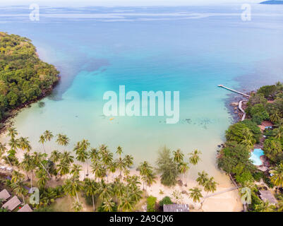 Tropical beach aerial view from drone with blue transparent sea water and coconut palm trees, seaside tourist hotel resort with beautiful landscape fo Stock Photo