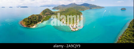 Tropical landscape aerial panorama with island coastline and beaches surrounded by transparent blue sea water, green rainforest, panoramic view from d