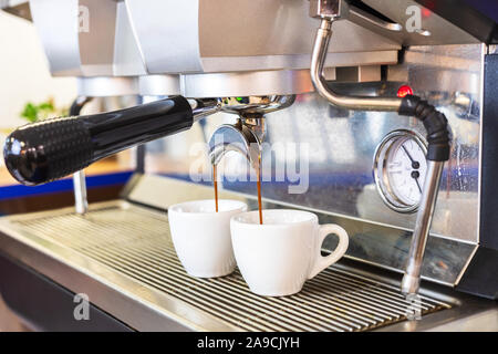 https://l450v.alamy.com/450v/2a9cjyh/espresso-coffee-machine-brewing-two-shots-in-white-cups-professional-italian-equipment-at-restaurant-or-bar-counter-close-up-2a9cjyh.jpg