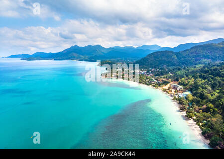 Aerial view of tropical island beach and coastline with transparent turquoise sea water and rainforest landscape, vacation holidays destination with t