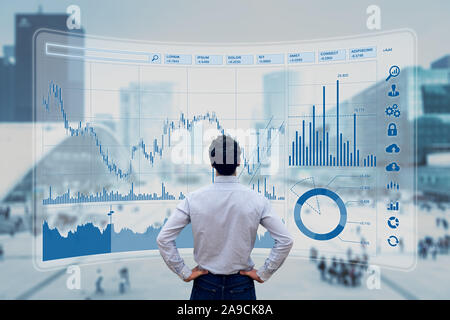 Finance trade manager analysing stock market indicators for best investment strategy, financial data and charts with business buildings in background Stock Photo