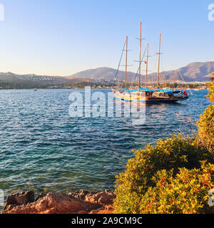 sunset at seaside with mountains and ship silhouette Stock Photo - Alamy