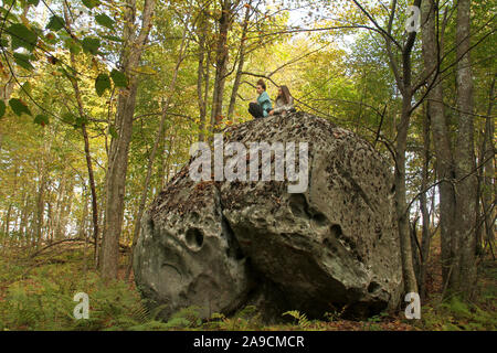 The Channels Natural Area Preserve, VA, USA. Young girls on top of boulder in the mountains. Stock Photo