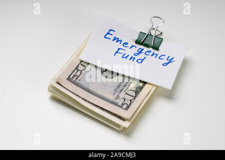 Emergency Fund Text On Card Over The Folded Bundle Of 50 Dollar Notes Stock Photo