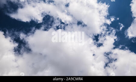 An image of a dark sky with white clouds Stock Photo