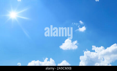 a bright blue sky with sun and clouds background Stock Photo