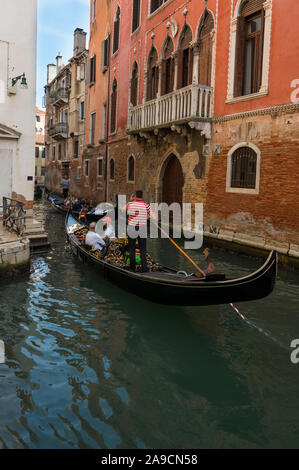 Riding a gondola through the canals of Venice, Italy Stock Photo