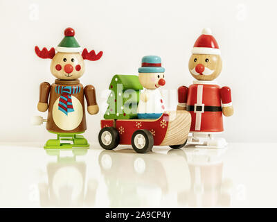 An image of three Christmas figures reindeer Santa Claus toys Stock Photo