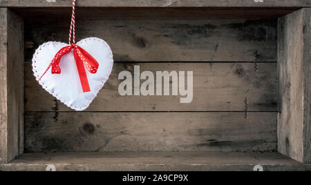 An image of a felt heart on a wooden background Stock Photo