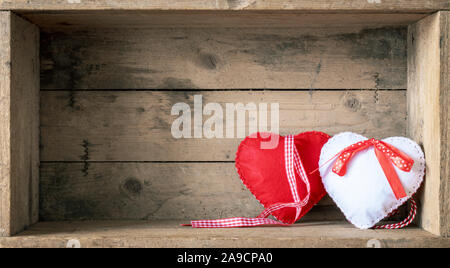 An image of two felt hearts on a wooden background Stock Photo