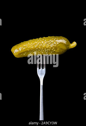 Single pickle on a fork Stock Photo