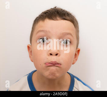 A boy portrait. Sillly face expression, wide eyes, funny lips. Stock Photo