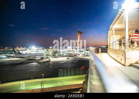 NEW YORK CITY - SEPTEMBER 20, 2019: View of historic TWA Hotel and runway with planes seen from John F. Kennedy Airport in Queens, New York at night