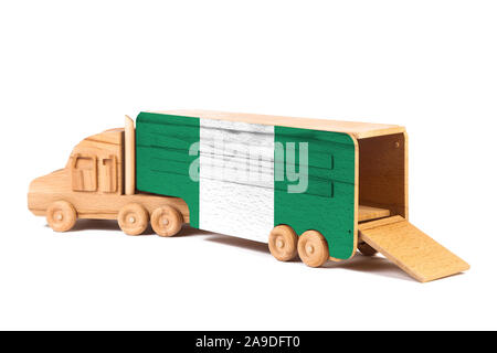 Close-up of a wooden toy truck with a painted national flag Nigeria. The concept of export-import,transportation, national delivery of goods Stock Photo