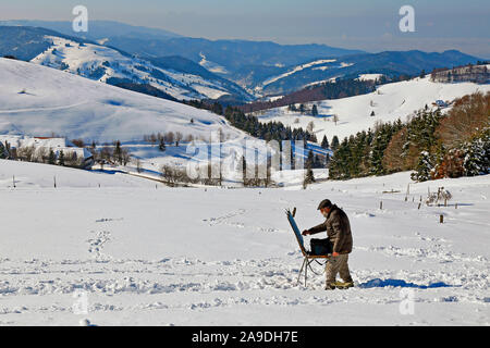 Painter at Schauinsland in winter at Freiburg, Southern Black Forest, Baden-Wuerttemberg, Germany