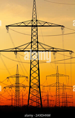 High voltage power lines in the morning light, Niederaussem, North Rhine-Westphalia, Germany Stock Photo