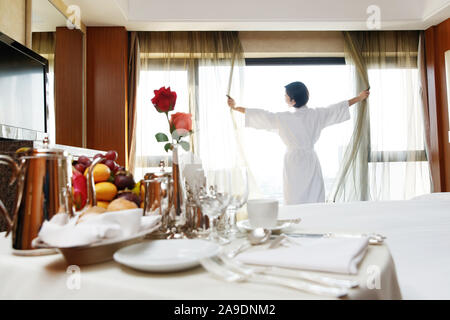 The young woman in a hotel room for coffee Stock Photo