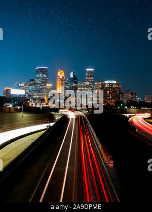 Light trails from cars going in and out of the city of Minneapolis