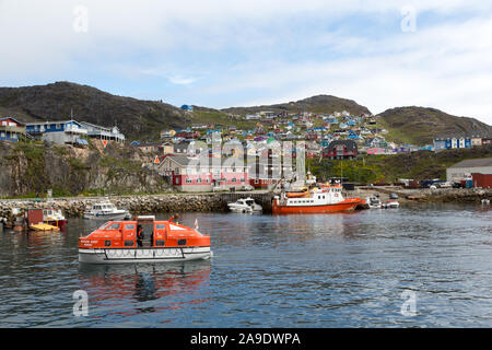 The tender from the Seabourn Quest cruise ship passing through the  harbour at the town of Qaqortoq on the west coast of Greenland. Stock Photo