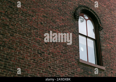 Arched window on old brick wall exterior Stock Photo